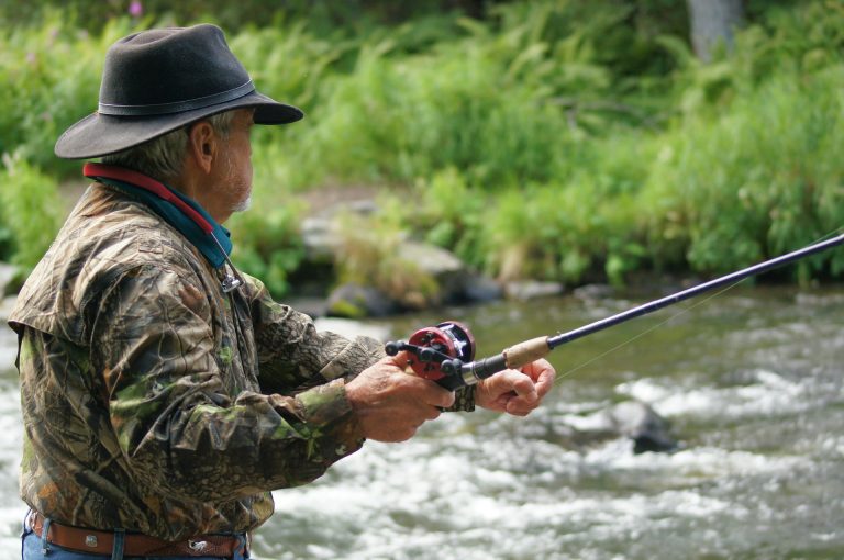 fly fisherman casting in a river